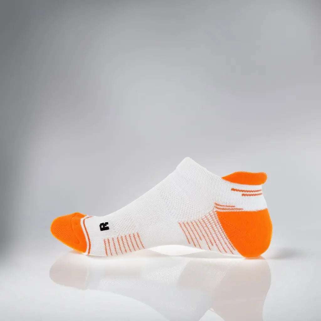 White and orange tennis low-cut socks with breathable mesh and secure fit strip for summer performance